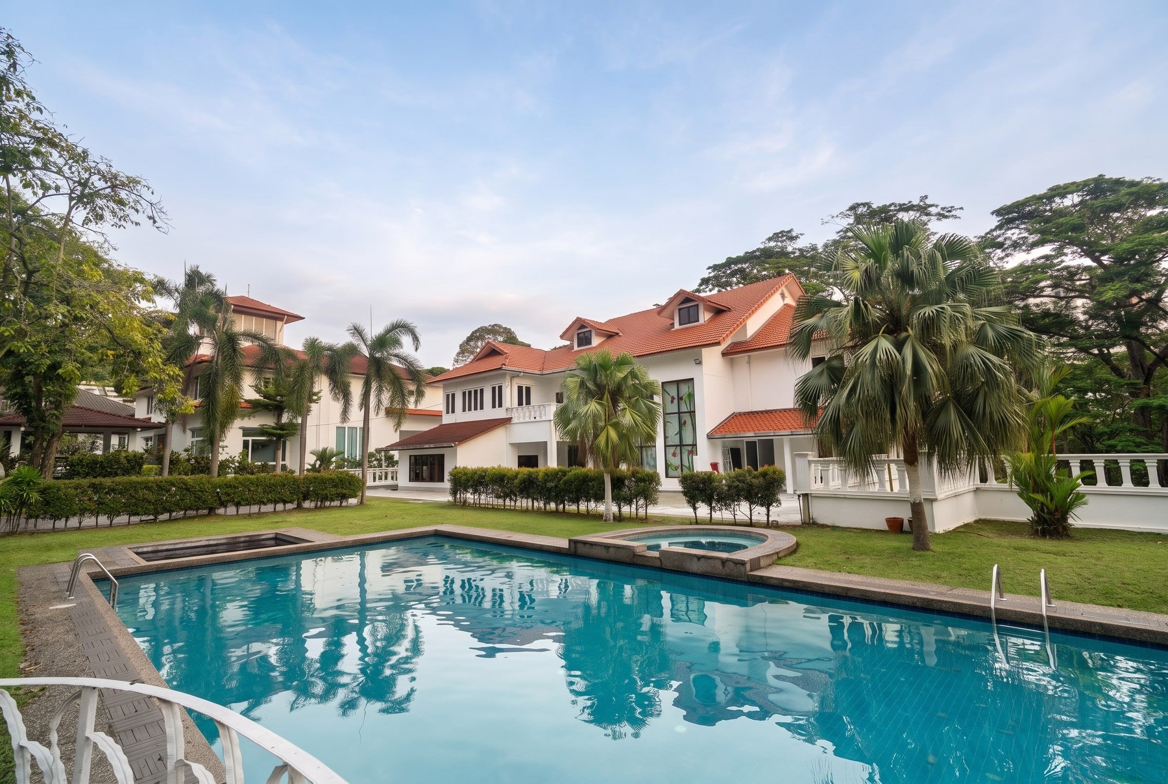 Trivelle Care's white bungalow and gardens with swimming pool in Country Heights, Kajang