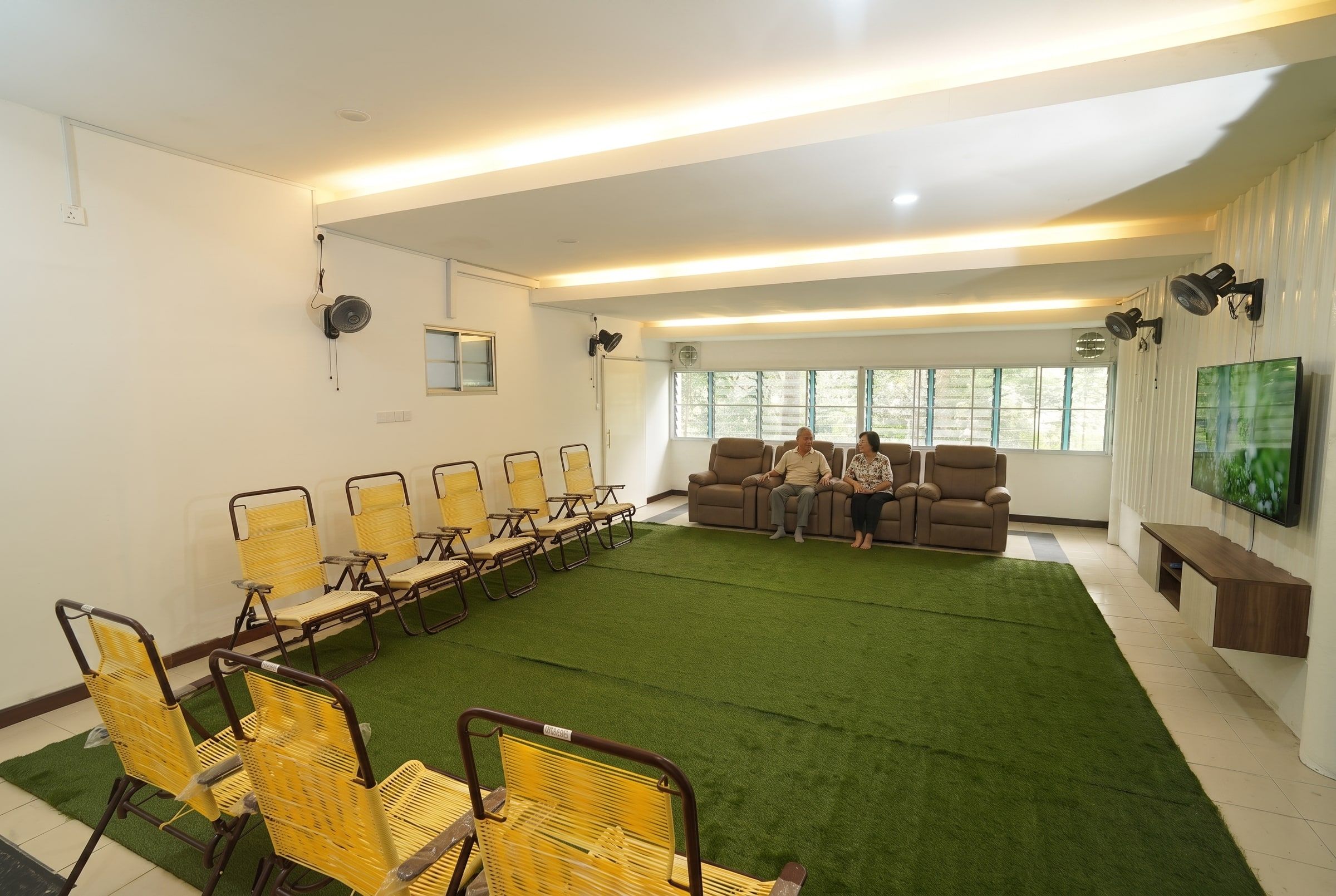 Residents relaxing in the TV lounge and activity area