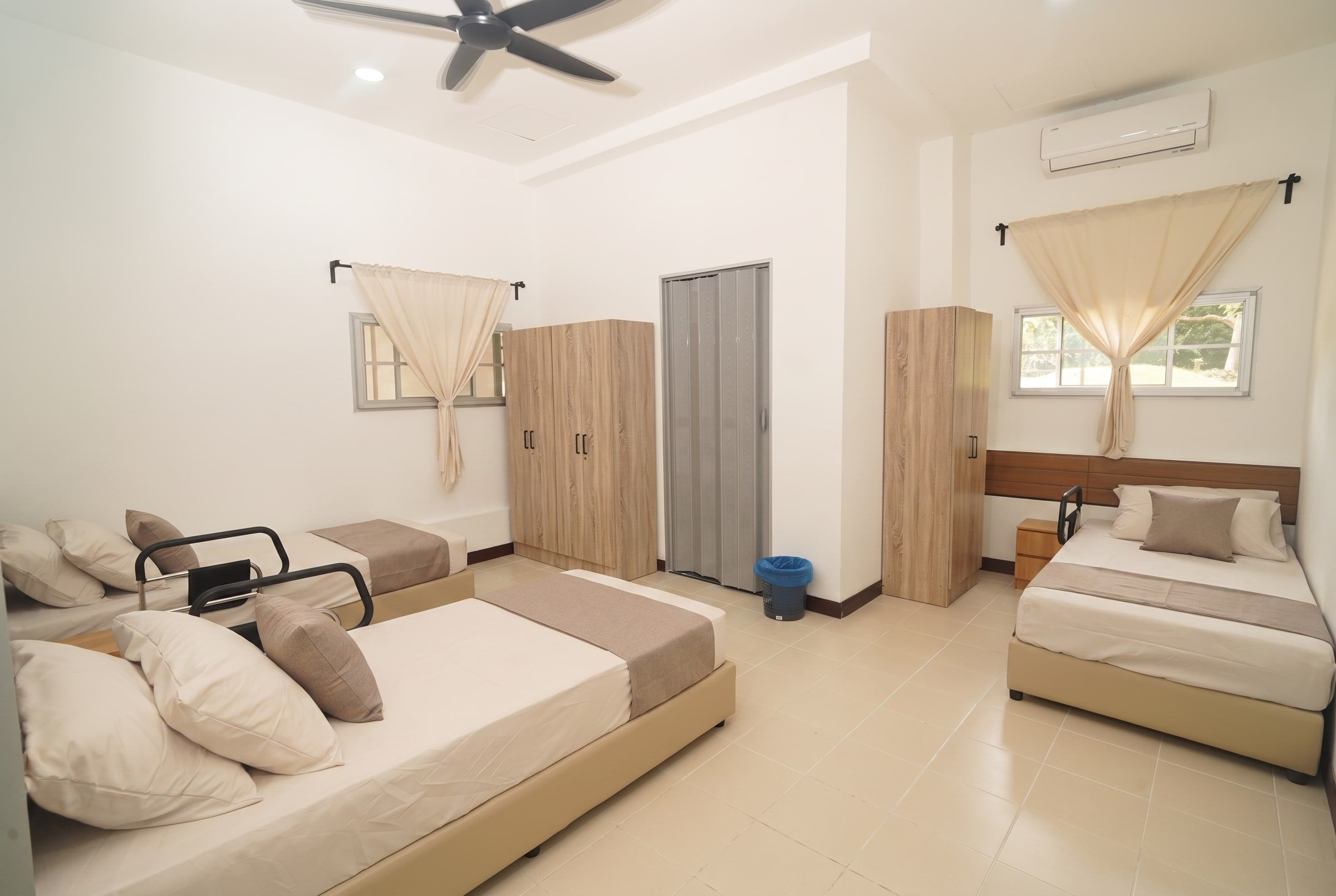 Bright 3-sharing bedroom with safety grab rails and garden windows