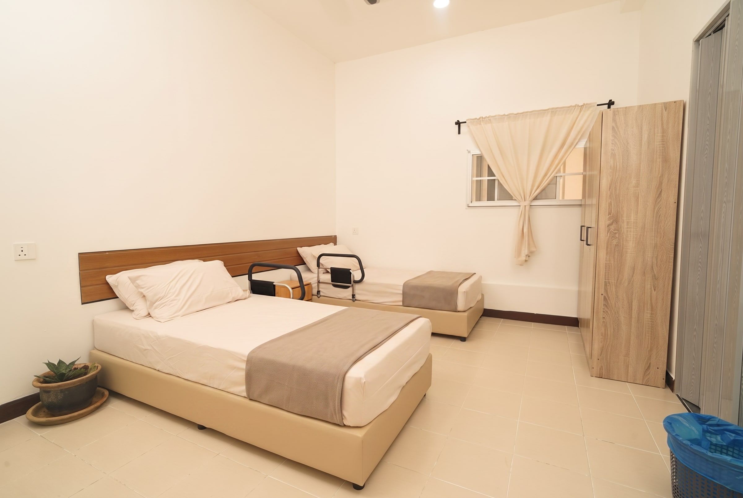 Twin sharing room with made-up beds and wardrobes